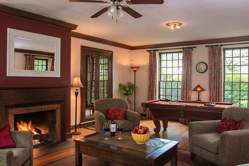 The guest living room with fireplace and billiard table
